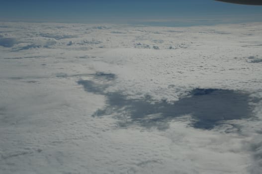 Aerial view of Clouds through flight window