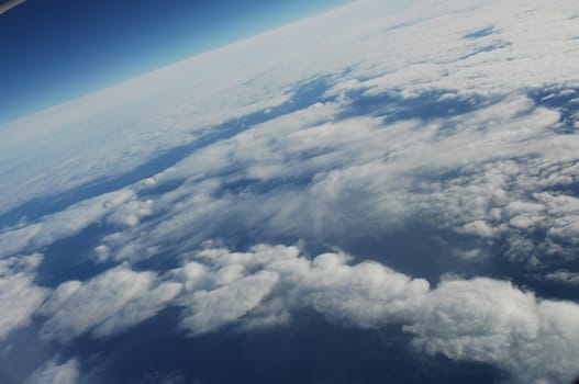 Aerial view of Clouds through flight window
