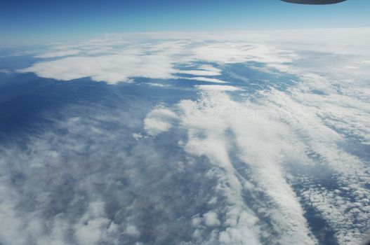 Aerial view of Clouds through flight window
