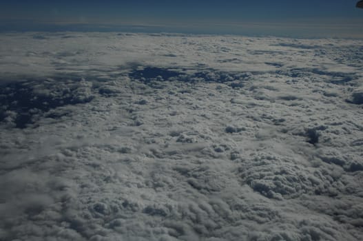 Aerial view of Clouds through flight window