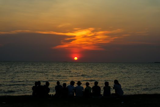 silhouette people family and pet meeting at beach and sea sand sunset background