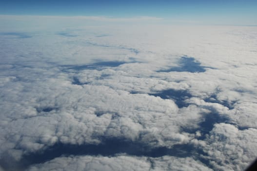 Aerial view of Clouds through flight window