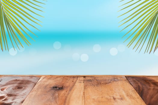 Selective focus of old wood table with beach in summer and  blue sky background for display your product.