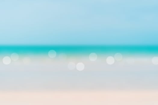 Blur summer bokeh beach with sun light and blue sky background.