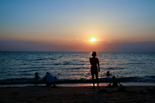 silhouette people family and pet at beach and sea sand sunset background