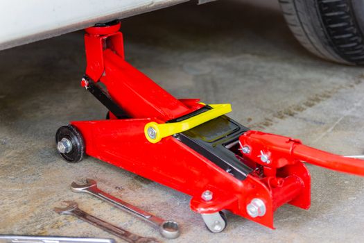 red tool jack lift car for repair check Maintenance of cars