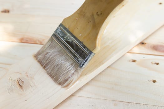 Paint brush with Shellac oil paint on wood