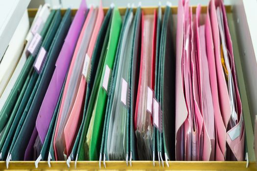 Files document of hanging file folders in a drawer in a whole pile of full papers, at work office, Business Concept Office document storage