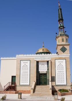 Small mosque against a blue sky background