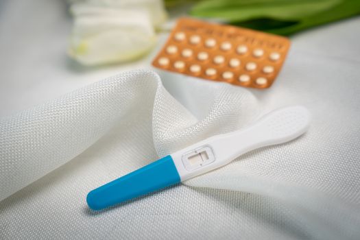 Pregnancy test and Birth control pill on white background. Concept for contraceptive