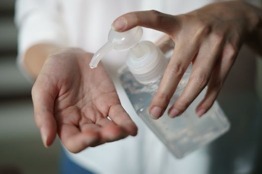 Woman washing hands with alcohol gel or sanitizer gel. corona virus or Covid-19 protection.