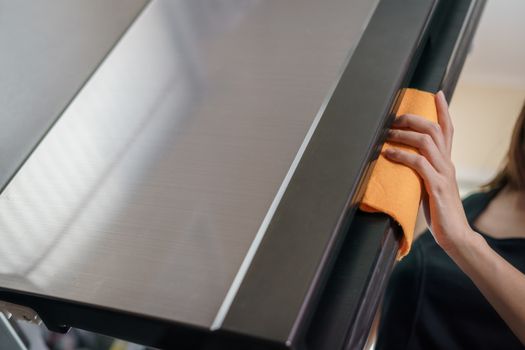 Women hands cleaning the Refrigerator at home kitchen.