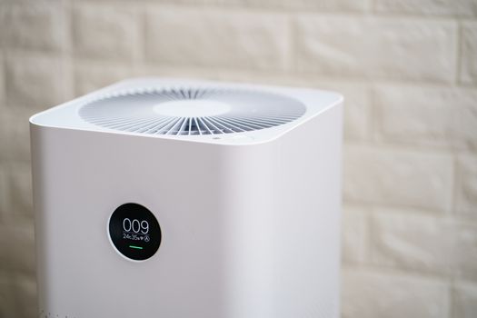 Closeup of Air purifier with monitor screen, show air quality in the room. PM2.5 concept.