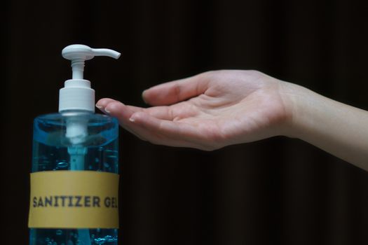 Woman washing hands with alcohol gel or sanitizer gel. corona virus or Covid-19 protection.
