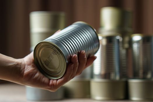 Woman hand with group of Aluminium canned food.