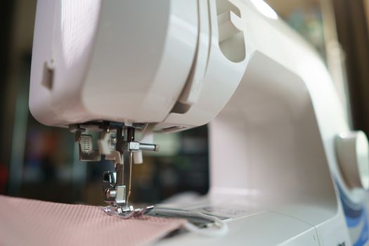 Closeup of fabrics and sewing machine for sewing an anti-virus face mask during the coronavirus pandemia.