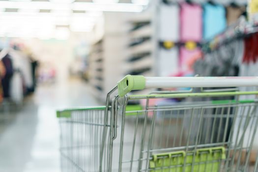 Supermarket with empty shopping cart.