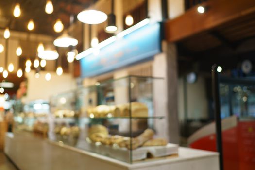 Blurred of supermarket with product shelves background image.