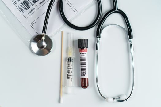 Blood test samples tube and swab collection kit in the laboratory, Coronavirus testing process (Fake QR code and barcode)