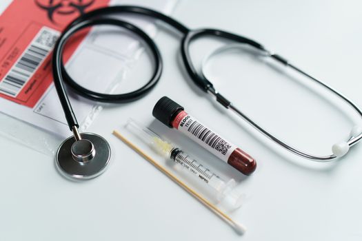 Blood test samples tube, reagent testing tube and swab collection kit in the laboratory, Coronavirus testing process. (Fake QR code and barcode)