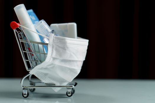 Shopping cart and sanitizer product with protective face mask corona virus or Covid-19 protection.