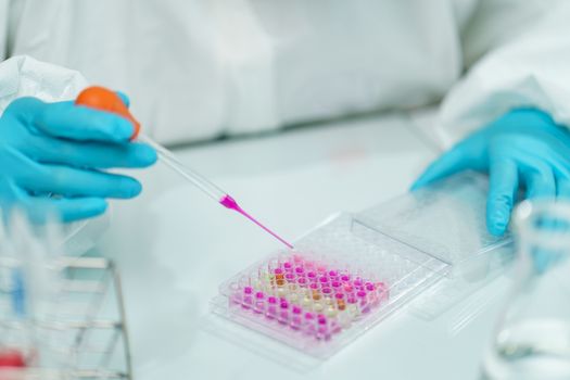 Scientist in laboratory with biological tube for analysis and sampling of Covid-19.