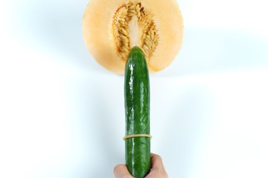 Melon and cucumber with condom on white background, Sex concept.