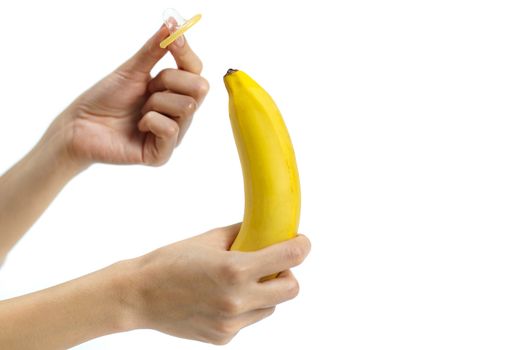 Condom on banana on white background, Safe sex concept. isolated