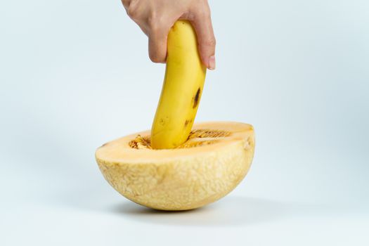 Melon and banana on white background, Sex concept.