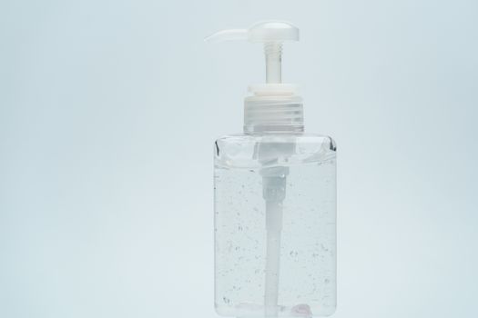 Clear hand sanitizer in a clear pump bottle on a white background.