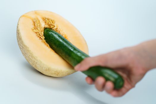 Melon and cucumber on white background