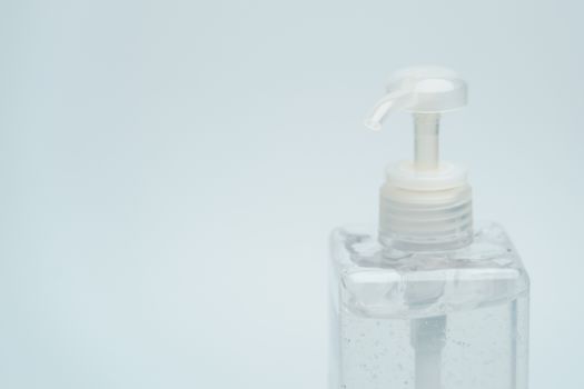 Clear hand sanitizer in a clear pump bottle on a white background.