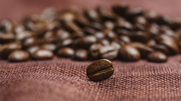 Roasted coffee beans pile on burlap