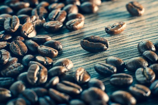 Coffee beans. On a wooden background.