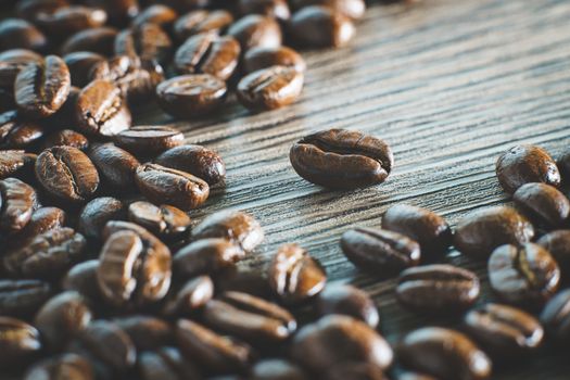 Coffee beans. On a wooden background.