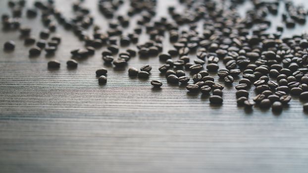 Coffee beans. On a wooden background.