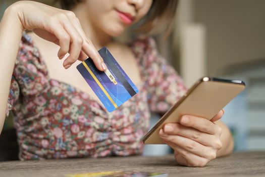 Online shopping concept : woman hands holding cradit card and using credit card online shopping.