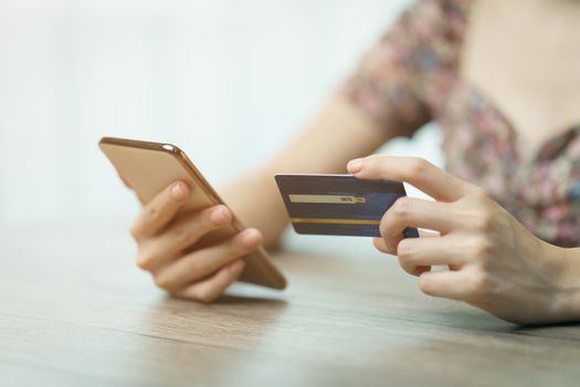 Online shopping concept : woman hands holding cradit card and using credit card online shopping.