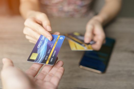 Woman is paying using a credit card, shopping and retail concept