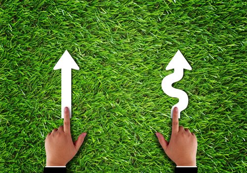 Business alignment concept, strategy and planning, hand and arrow on green grass background