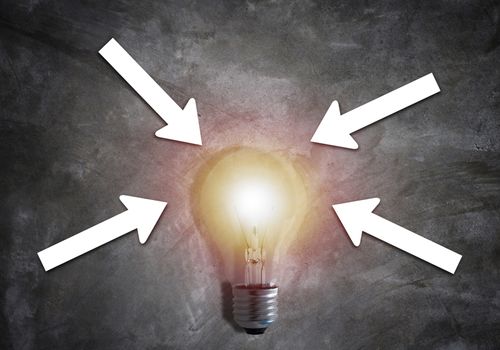 Business alignment concept, strategy and planning, light bulb and white arrow on concrete background