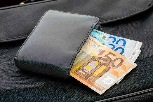 A black leather wallet with Euro banknotes