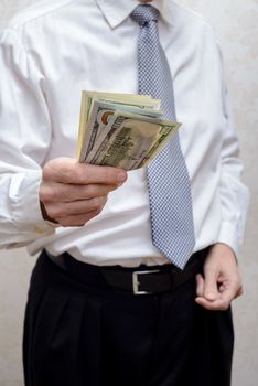 Corrupted businessman, or politician, offering a Dollar banknotes bribe