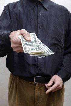 Corrupted businessman, or politician, offering a Dollar banknotes bribe