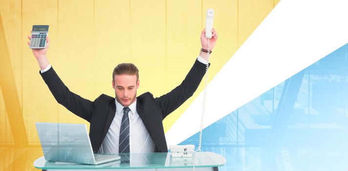 Businessman cheering holding calculator and telephone against window overlooking city