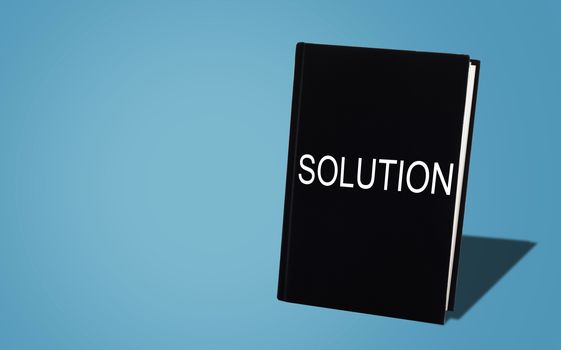 Business solution, solving problem, strategy and planning concept, black book on blue background