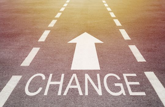 Business change concept, white arrow on road background