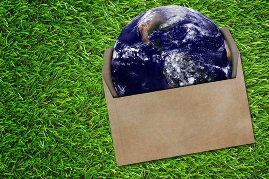 Communication concept,  the earth and envelope on green grass background, Elements of this Image Furnished by NASA
