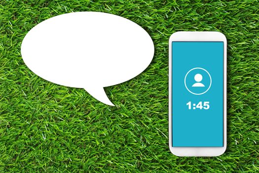 Communication concept, mobile phone and bubble chat on green grass background