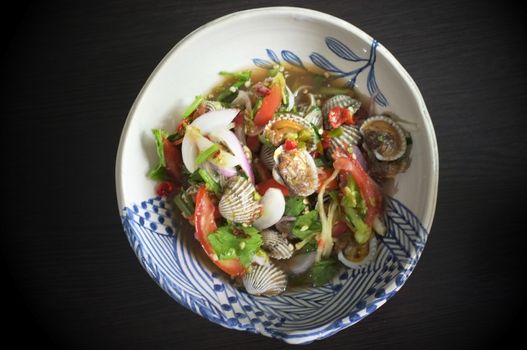 Cockles salad / Hot and spicy shellfish blood cockles salad mix vegetable tomato herb and spices , thai style food